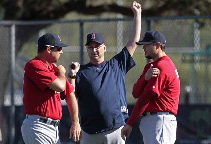 Boston Red Sox manager Terry Francona, center, talks with pitchers Tim Wakefield, left, and Josh Beckett at the beginning of their first day of spring training today.