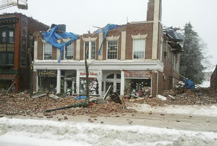 This photo provided by the Middletown, Conn., Police Department shows a partially collapsed building on Main Street in Middletown, Conn., Wednesday. Employees in the building escaped uninjured. The collapse came after days of heavy snowfall followed by rain.