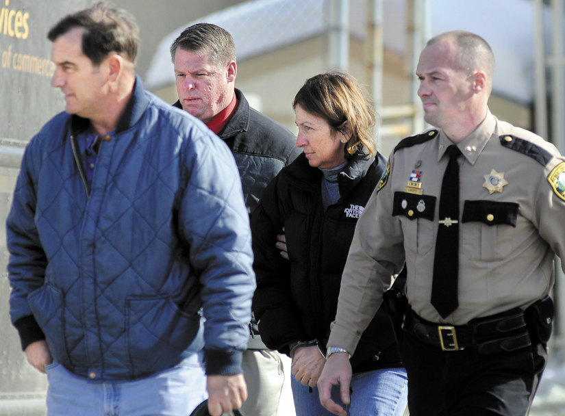 Staff photo by Andy Molloy ARRESTED: Chelsea Selectman Carole Swan, second from right, is led to Kennebec County jail Thursday in handcuffs are being arrested at the sheriff's office in Augusta. Swan was accompanied by, from left, her husband, Marshall Swan; after Kennebec County Sheriff's Department Detective David Bucknam; and Sheriff Randy Liberty.