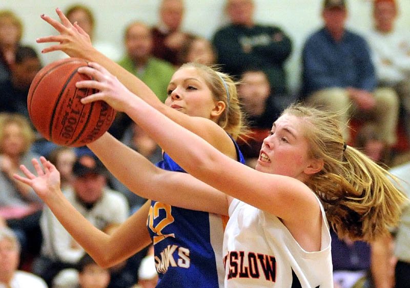 MAD SCRAMBLE: Winslow’s Megan Richards, right, fights for the rebound with Hermon’s Britney Hamlin in the third quarter of an Eastern Maine Class B preliminary game Tuesday night in Winslow. Winslow lost 40-33.