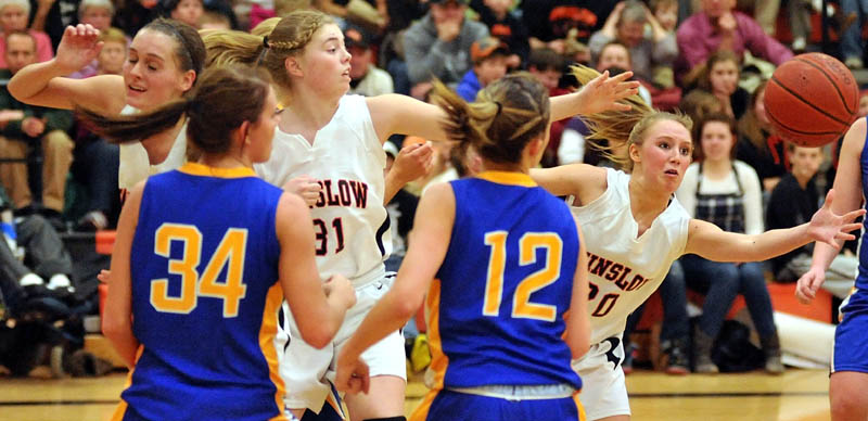REACHING OUT: Winslow’s Lynsey Vigue, right, keeps her eye on the loose ball during the third quarter of an Eastern Maine Class B preliminary game against Hermon on Tuesday night in Winslow. Winslow lost 40-33.