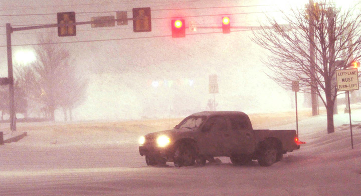 A truck gets stuck in the snow at a major intersection in Tulsa, Okla., today.