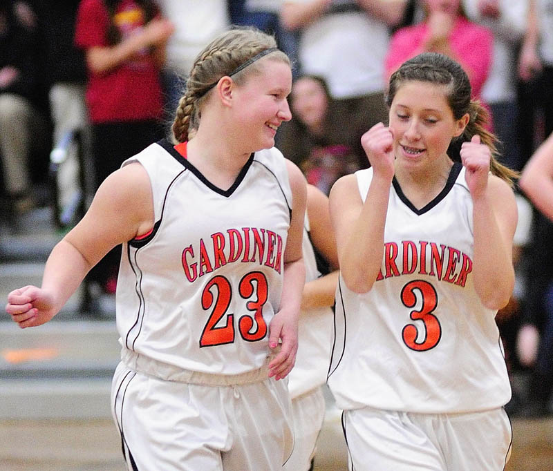 Staff photo by Joe Phelan Gardiner Tigers Liz Kelley, left, and Kelsey Moody celebrate just after the game ended on Tuesday night in the John A. Bragoli Memorial Gym at Gardiner Area High School. Gardiner won the game and advance to the tournament.