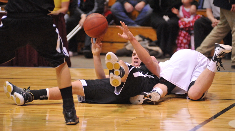 Michael Trahan, center, of Gardiner fights for a loose ball with an Ellsworth player.