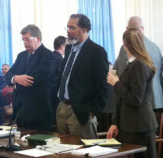Rory Holland, center, listens as his sentence is handed down in York County Superior Court on Monday. His lawyers are standing with him – Cliff Strike on the left and Amanda Doherty on the right.