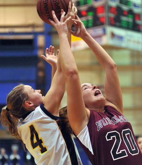 Emilee Reynolds, right, of Nokomis fights for a rebound with Vanessa Davis of Medomak Valley during the Eastern Class B girls' championship game at the Bangor Auditorium. Nokomis advanced to its second straight state final.
