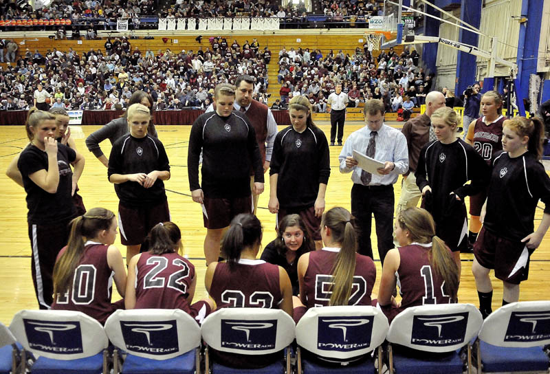 ON THE SAME PAGE: Nokomis girls basketball coach Kori Dionne, center, talks to her team during a timeout in the Eastern Class B semifinals Wednesday at the Bangor Auditorium. Nokomis will play in its second straight Eastern B final, when it faces Medomak Valley at 7:05 tonight.