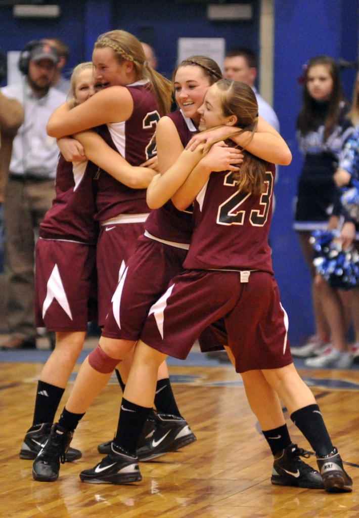 Nokomis players celebrate after their 49-43 win over Presque Isle in an Eastern Class B semifinals at the Bangor Auditorium.