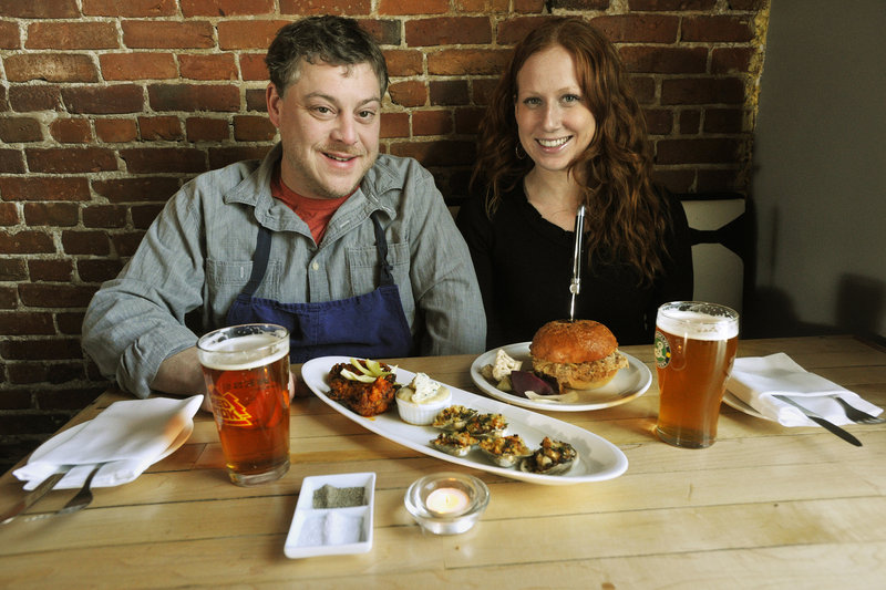 East Ender partners Mitchell Gerow and Megan Schroeter with their buffalo wings, clams casino and pulled pork sandwich.