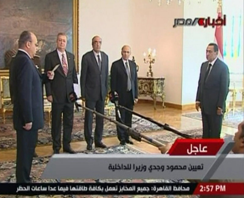 In an image taken from Egypt State TV, President Hosni Mubarak, right, swears in new Interior Minister Mahmoud Wagdi, front left. Mubarak has replaced the Cabinet that was dissolved as a concession to anti-government protests. The U.S. rejected Mubarak’s announcement of a new government that dropped his highly unpopular interior minister.