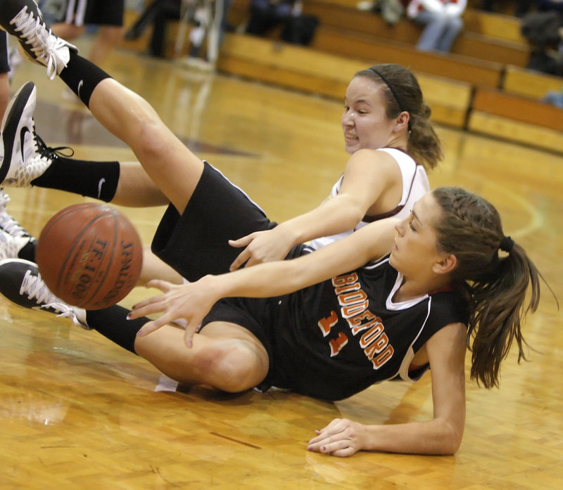 Alyson Roy, front, of Biddeford battles for a loose ball with Thornton Academy's Lauren Titus.