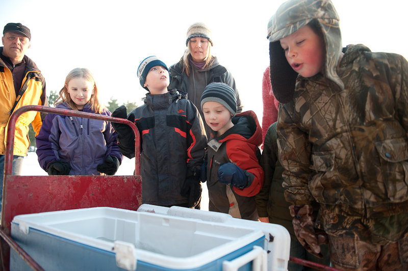 Fish in a cooler at Crystal Lake draw attention. The event’s ice fishing derby for kids attracted 950 young anglers.