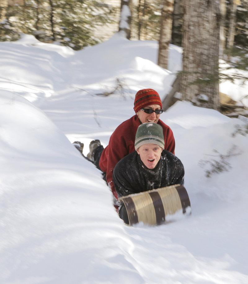 Angela and Andy Russ take a toboggan down the chute. The family also rides on inflated tubes and maneuverable sleds.