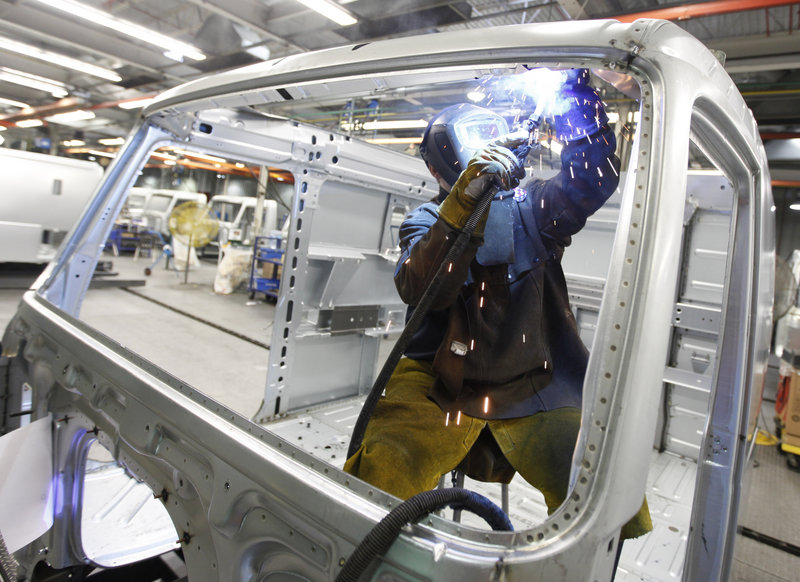 An employee welds the frame of a truck’s cab on an assembly line at the Volvo plant in Dublin, Va. The factory sector expanded in January at the fastest pace in seven years as manufacturers reported a sharp jump in new orders.