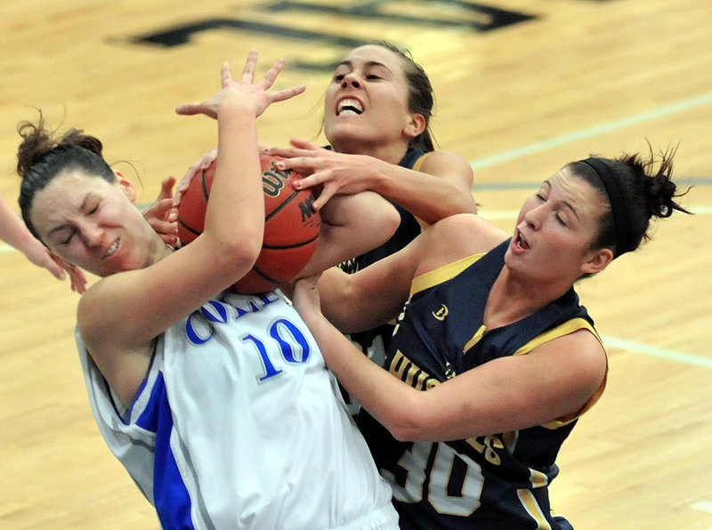 Jules Kowalski, left, of Colby struggles with Kaylie DeMillo, right, and Haley Jordan of the University of Southern Maine for a rebound Tuesday night during their game at Waterville. Colby took charge with a run late in the first half and posted a 74-45 victory.