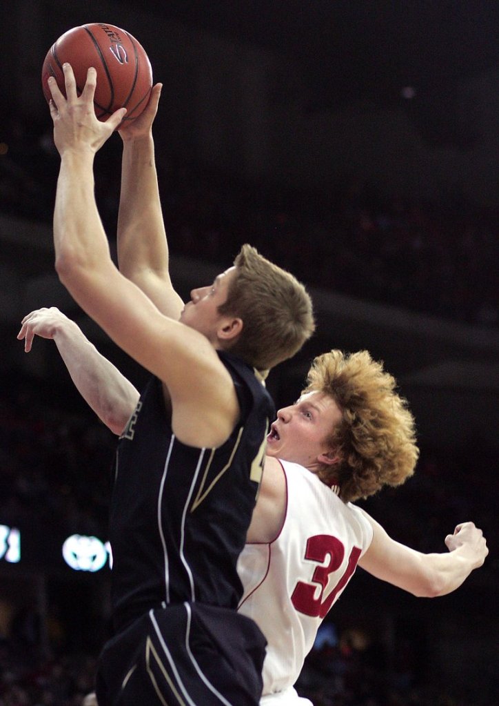 Patrick Bade of Purdue drives for a shot while defended by Wisconsin's Mike Bruesewitz in Wisconsin's 66-59 victory.