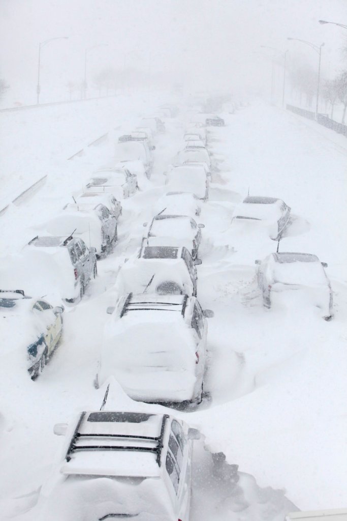 Stranded cars wait in ghostly lines Wednesday on Lake Shore Drive in Chicago after a blizzard dumped 20 inches on the city, the third-largest amount on record. Some drivers toughed out the wintry conditions for up to 12 hours overnight on the city’s showcase thoroughfare.