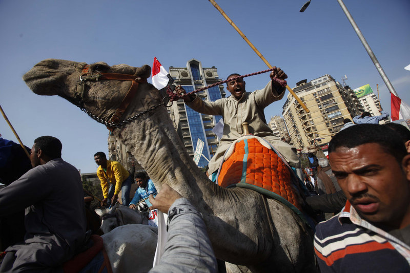 Mubarak supporters riding camels and horses charge into Tahrir Square in Cairo, Egypt, on Wednesday. The attack on anti-governmnent demonstrators appeared well planned, suggesting regime complicity, political observers say.