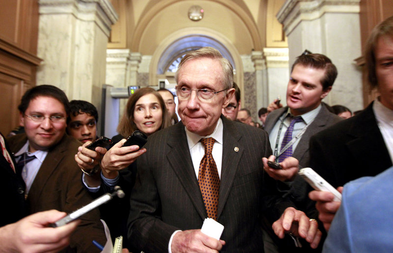 Senate Majority Leader Harry Reid of Nevada is pursued by reporters on Capitol Hill in Washington on Thursday, after a news conference to discuss deficit reduction.
