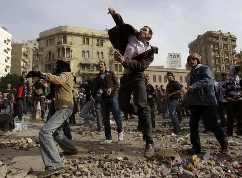 Anti-government protesters throw rubble at Mubarak backers as clashes intensify in Cairo.