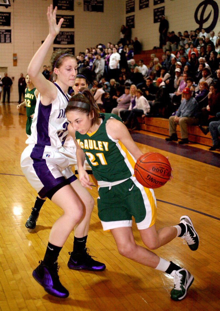 Alexa Coulombe of McAuley heads to the baseline Thursday night while attempting to drive past Marissa MacMillan of Deering during undefeated McAuley's 47-43 overtime victory.