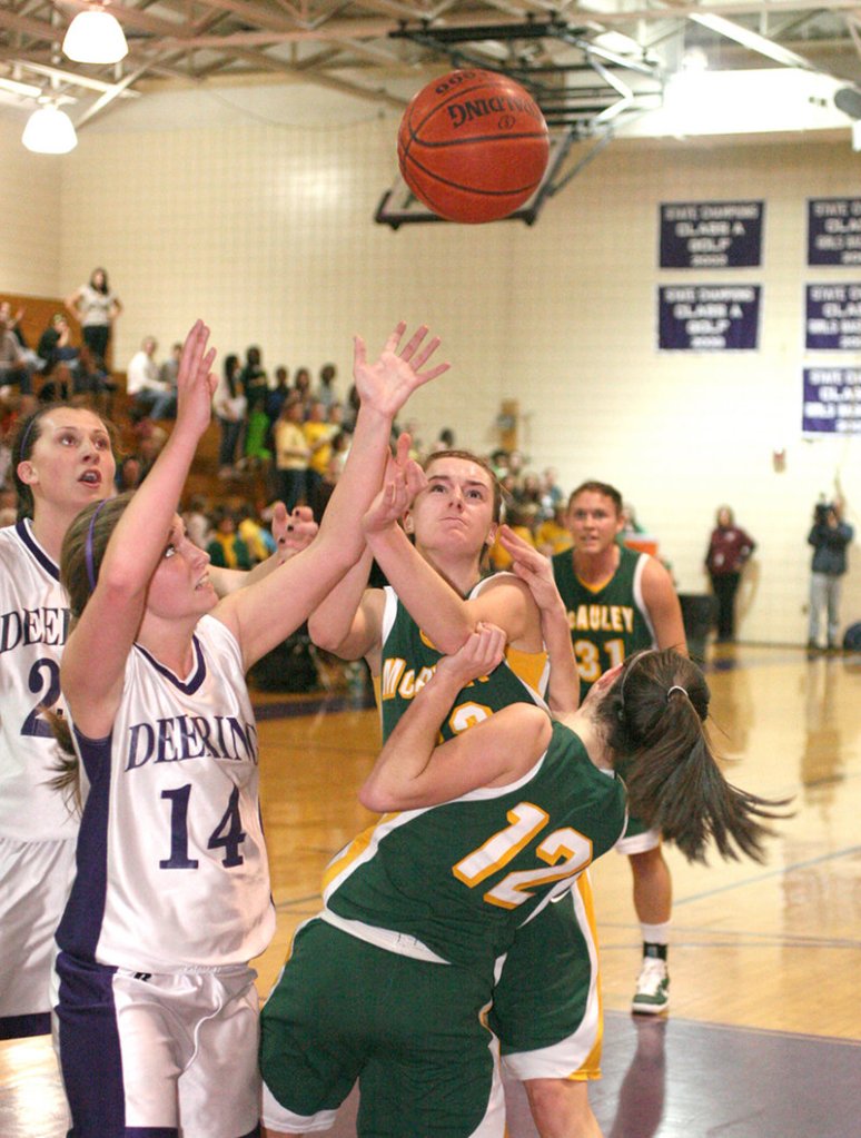 The rebound's coming down and the players converge Thursday night. Emily Cole of Deering, 14, goes for it with Allie Clement, middle, and Sadie DiPierro, 12, of McAuley. Ella Ramonas of Deering is at left.
