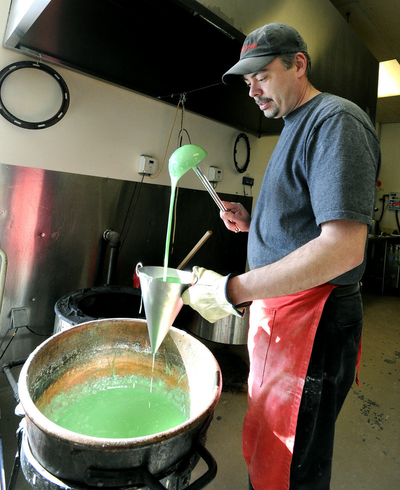 Candy maker Steve Quimby pours heated candy to create spearmints at Haven’s Candies in Westbrook.