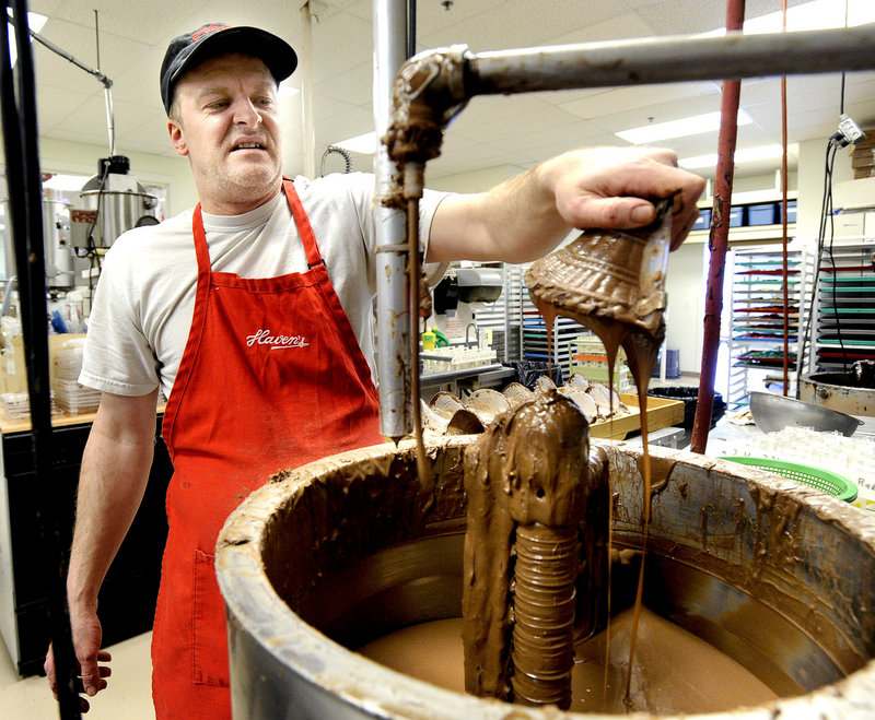 Paul Norweg holds a see-through mold to make chocolate baskets at Haven’s Candies in Westbrook.