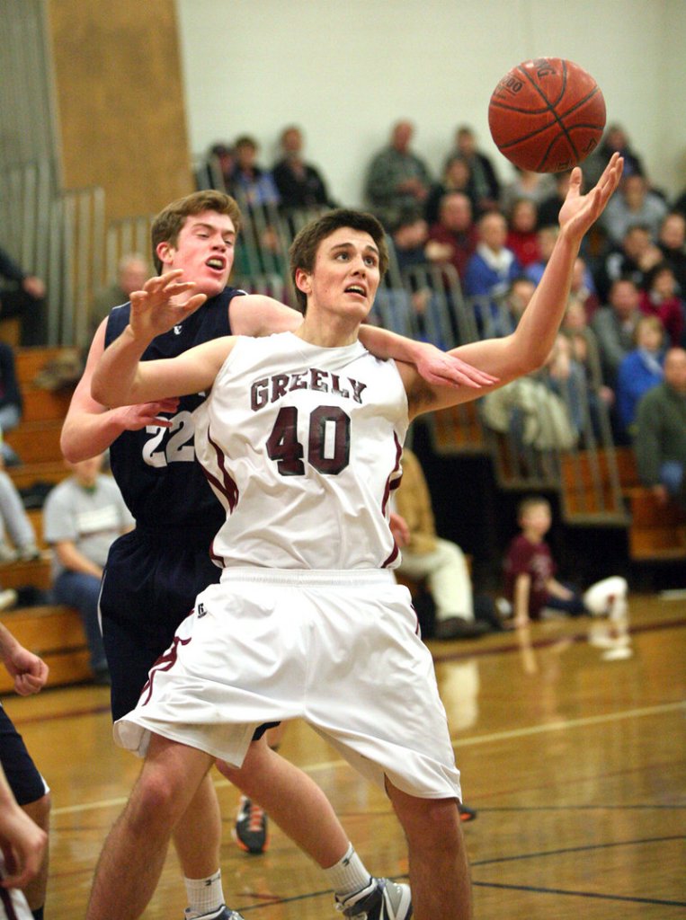 Tanner Storey of Greely holds inside position against Connor Ertz of Yarmouth while attempting to control a rebound Friday night in the first half of Yarmouth's 53-51 victory.