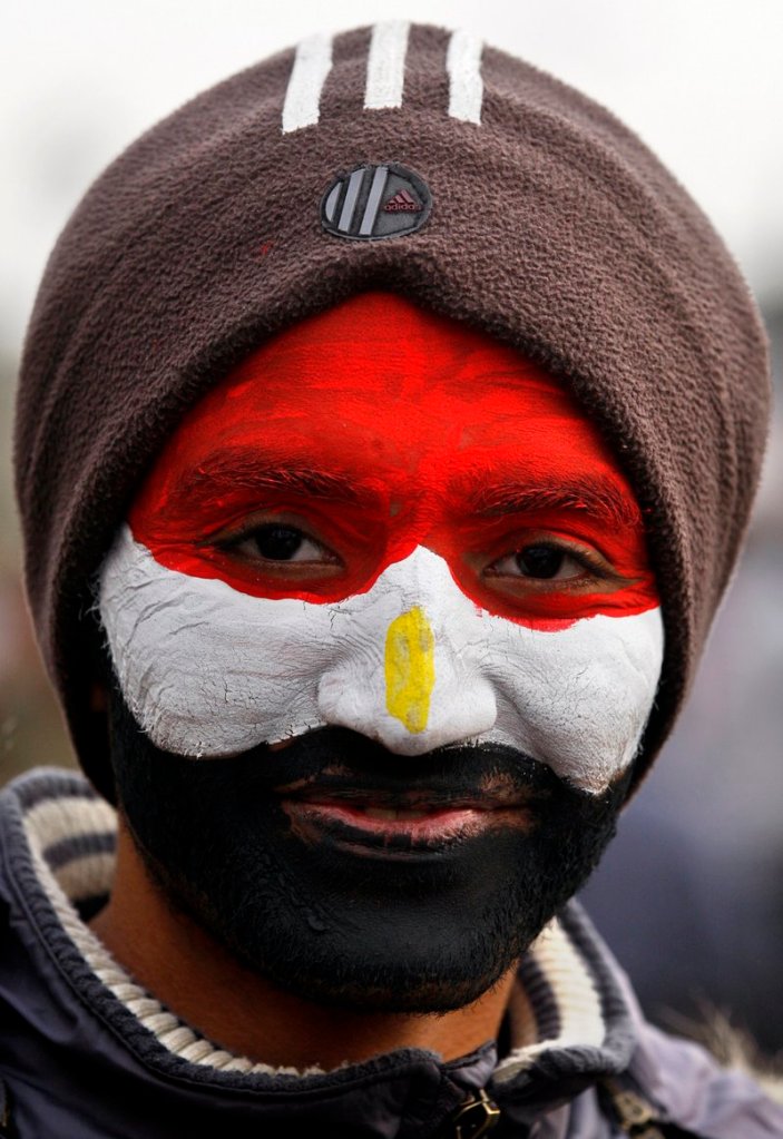An anti-government protester wears the colors of the Egyptian flag on Friday in Cairo's Tahrir Square.