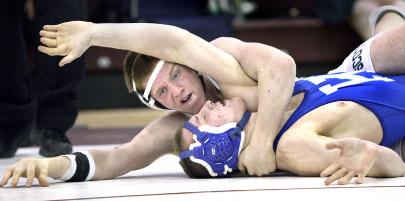 Troy Severance of Bonny Eagle attempts to pin Ian Weigle of Kennebunk during their 160-pound semifinal consolation match at the Western Class A regional meet Saturday.