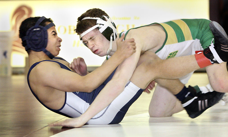 Lucas Dion, right, of Massabesic takes down Kidayer Aljubyly of Portland during their 112-pound consolation-round meeting. Dion won the match with a pin.
