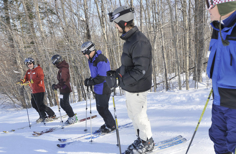 Instructor Ray Walters, of Concord N.H., far left, gives advice during a telemark lesson Saturday.