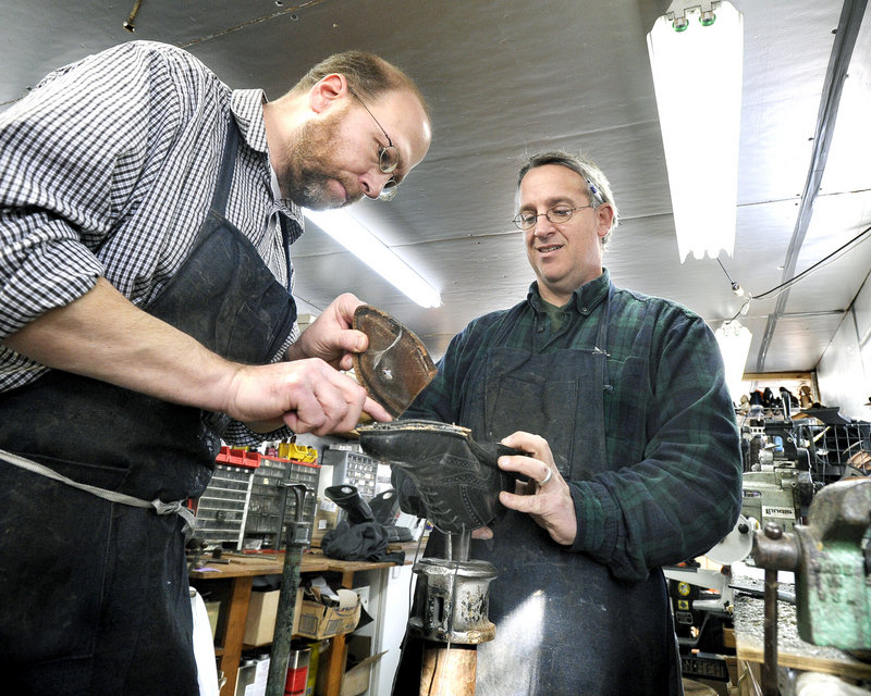 Ray Routhier, left, works on replacing the sole of a shoe with Paul Rowland at Paul's Shoe Repair in Westbrook. "Rubber soles are a much better value," Rowland said.