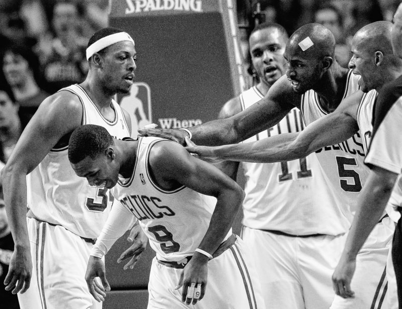 Boston’s Rajon Rondo is surrounded by teammates, from right, Ray Allen, Kevin Garnett Glen Davis and Paul Pierce, during the second half of the Celtics’ 91-80 win over the Orlando Magic on Sunday at Boston. Rondo had a season-high 26 points.