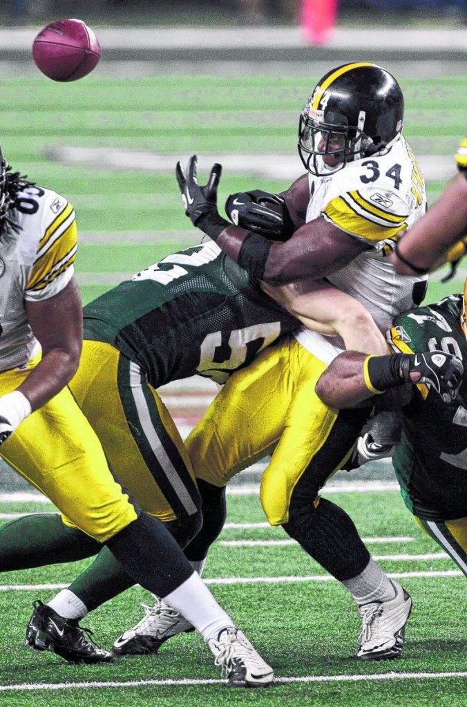 Green Bay’s Clay Matthews tackles Rashard Mendenhall, forcing a fumble during the second half Sunday. Matthews said, “You play to be world champions, and that’s what we are today.”