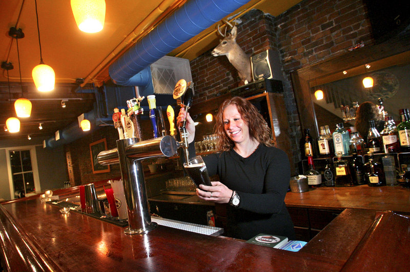 Meg Schroeter, one of the owners of the East Ender, draws a beer at one of the two bars. The East Ender also carries 30 to 40 different bottled beers.