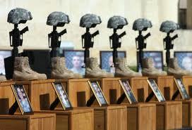 Helmets on rifles and photos of the victims mark a memorial service for the 13 people killed at Fort Hood.