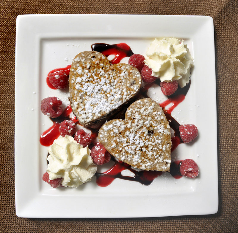 Dana Moos’ Chocolate Ricotta Pancakes with chocolate sauce, raspberry coulis and whipped cream.