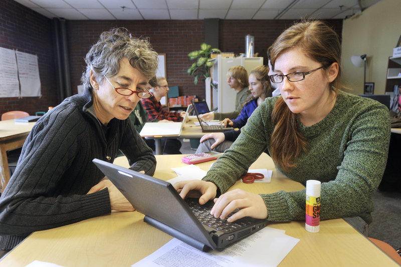 Teacher Susan McCray works with humanities student Annie Laughlin on Monday at Casco Bay High School in Portland. A recommendation to boost enrollment coincides with the school’s second lottery to select the next freshman class from an overflow list of eighth-grade applicants.