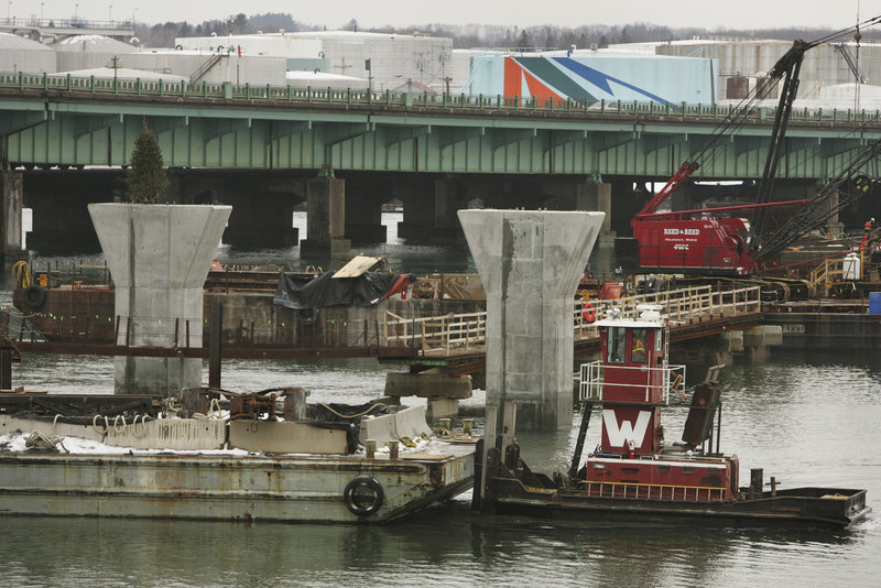 Construction proceeds on the new Veterans Memorial Bridge over the Fore River. Periodic lane closures on the old bridge will start Wednesday.