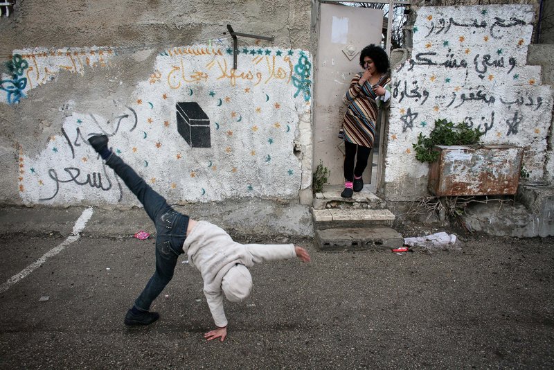 A Palestinian boy plays outside his house Monday in the east Jerusalem neighborhood of Sheikh Jarrah. The plan for Jewish homes must clear bureaucratic obstacles.
