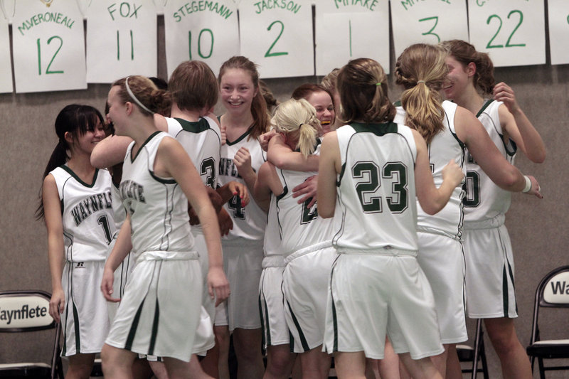 The Waynflete girls’ basketball team celebrates after defeating Cape Elizabeth 43-37 at Waynflete on Monday. Lydia Stegemann scored 20 points to propel the Class C Flyers (14-3) past the Class B Capers.