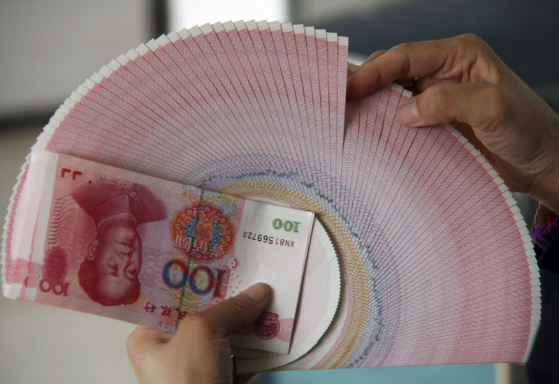 A bank teller count bank notes at a bank in Linyi, China. China's central bank raised interest rates for the second time in just over a month in a bid to dampen high inflation.