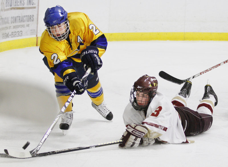 Sam Canales of Thornton Academy dives in an attempt to stop Tim Hanley of Falmouth from clearing the puck. The teams will meet again Feb. 19 in Falmouth.