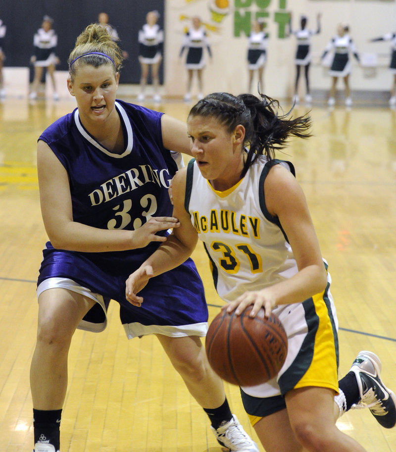 Rebecca Knight of McAuley, who was held to eight points, looks for room to drive against Kayla Burchill of Deering during Deering's 38-35 victory Thursday night.