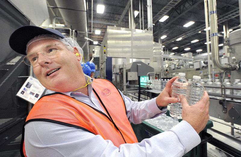 William Maples, supply chain director for the Northeast for Nestlé, shows two bottles that were overfilled and rejected at the Poland Spring bottling plant in Hollis.