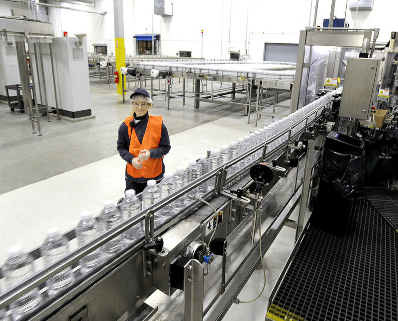 Production technician Louise MacGregor keeps a eye on a line of just-filled bottles at the Poland Spring bottling plant in Hollis. Some machines can fill 1,200 bottles per minute.