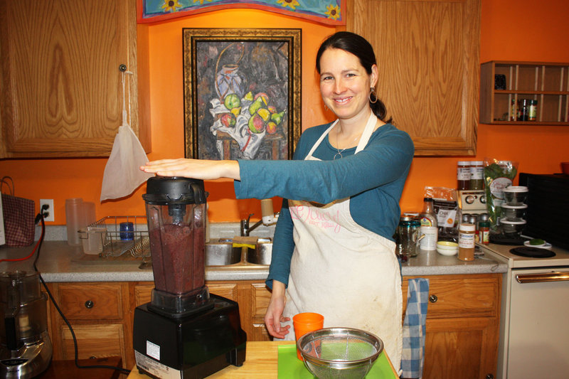Elizabeth Fraser creates a smoothie from kale, blackberries, blueberries, bananas, cinnamon and water in her Munjoy Hill demonstration kitchen.