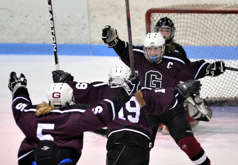 Michaela Finnegan of Greely prepares to welcome her teammates Friday night after scoring the first goal of a 3-2 victory against Winslow in an Eastern semifinal.